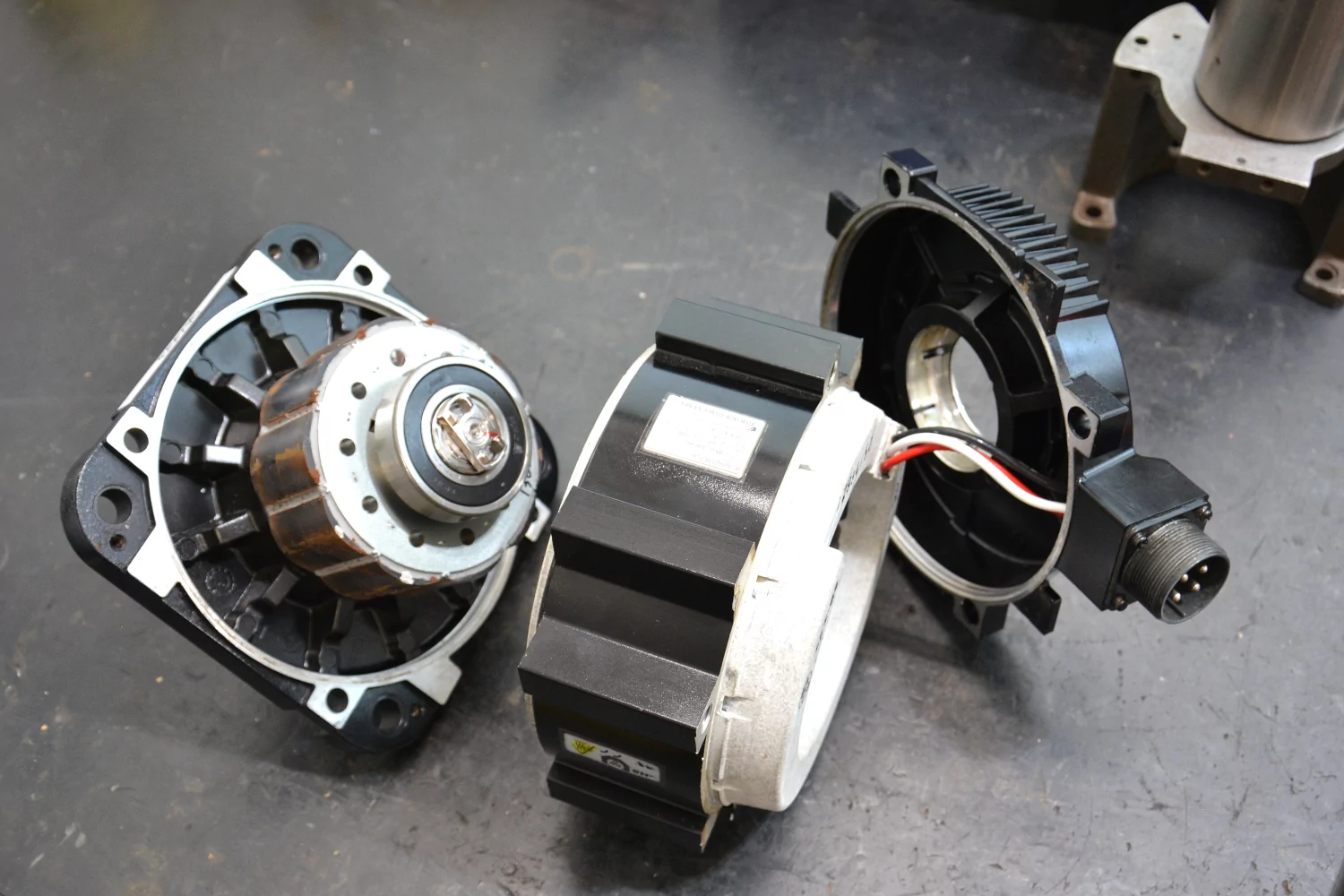 The motor completely disassembled into individual parts.